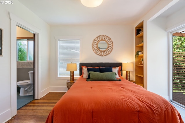 9935 N Lombard St, Portland, OR 97203 - bedroom with dark wood-style flooring, baseboards, and ensuite bathroom