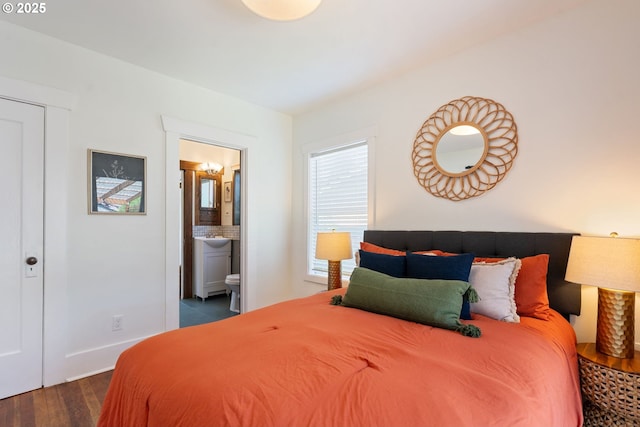 9935 N Lombard St, Portland, OR 97203 - bedroom with dark wood-type flooring, ensuite bathroom, and baseboards