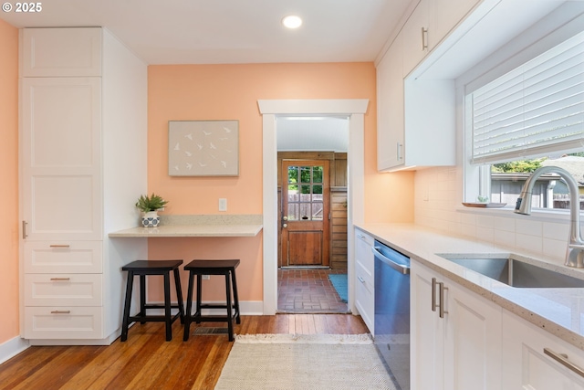 9935 N Lombard St, Portland, OR 97203 - kitchen with a sink, dishwasher, light wood-type flooring, white cabinetry, and recessed lighting