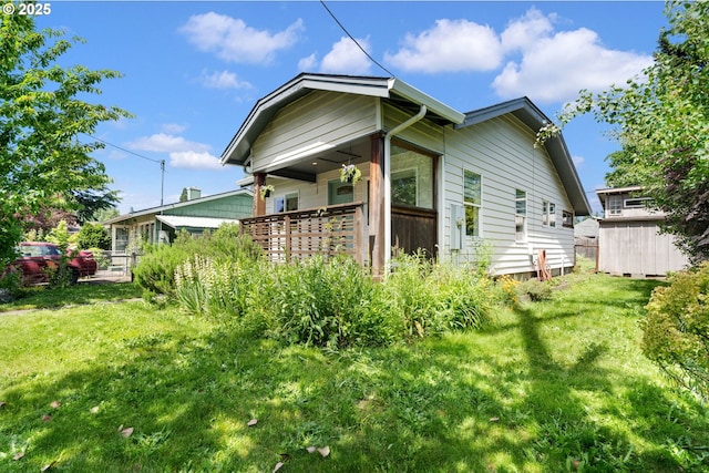 9935 N Lombard St, Portland, OR 97203 - view of side of property with a lawn and an outdoor structure
