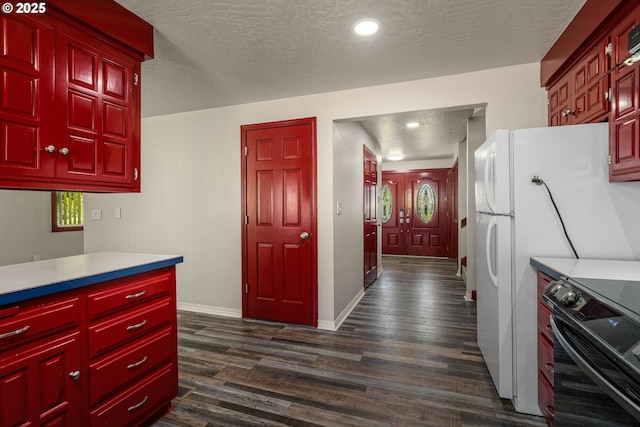 16170 Mcbee Rd, Dallas, OR 97338 - kitchen featuring range, dark wood-type flooring, a textured ceiling, baseboards, and healthy amount of natural light