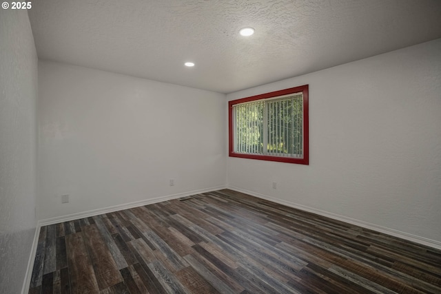 16170 Mcbee Rd, Dallas, OR 97338 - empty room featuring dark wood-style floors, baseboards, recessed lighting, and a textured ceiling
