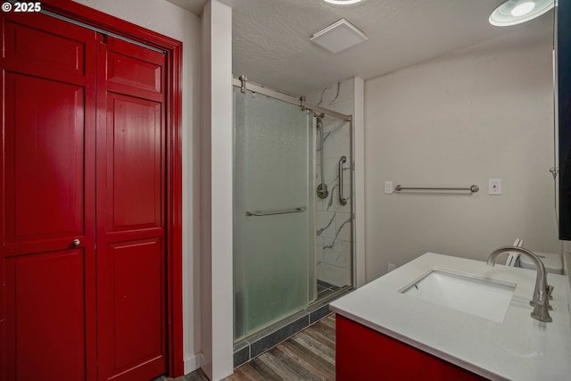 16170 Mcbee Rd, Dallas, OR 97338 - full bath featuring a stall shower, vanity, wood finished floors, a closet, and a textured ceiling