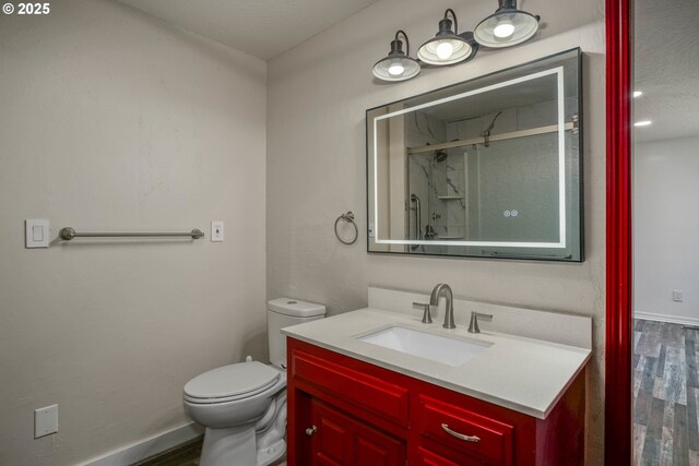 16170 Mcbee Rd, Dallas, OR 97338 - full bathroom featuring wood finished floors, vanity, a stall shower, toilet, and baseboards