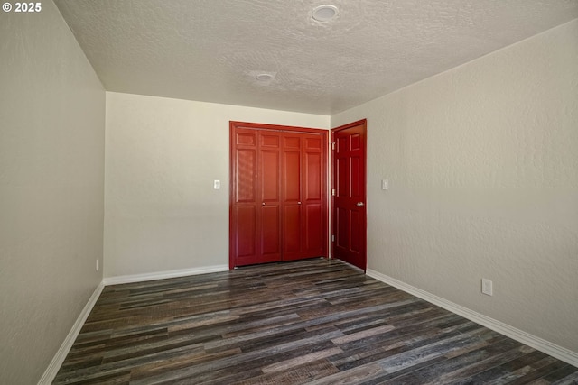 16170 Mcbee Rd, Dallas, OR 97338 - unfurnished room with dark wood finished floors, baseboards, and a textured ceiling