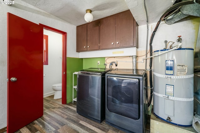 16170 Mcbee Rd, Dallas, OR 97338 - washroom featuring secured water heater, separate washer and dryer, cabinet space, wood finished floors, and a textured ceiling