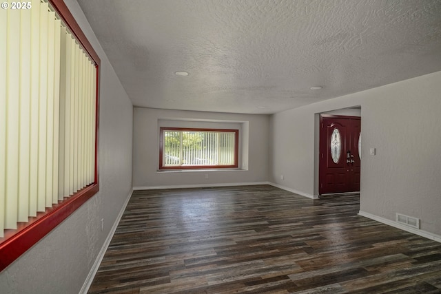 16170 Mcbee Rd, Dallas, OR 97338 - unfurnished living room featuring dark wood finished floors, a textured ceiling, baseboards, and stairway