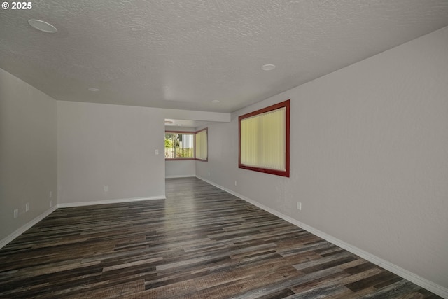 16170 Mcbee Rd, Dallas, OR 97338 - spare room with dark wood-type flooring, a textured ceiling, and baseboards