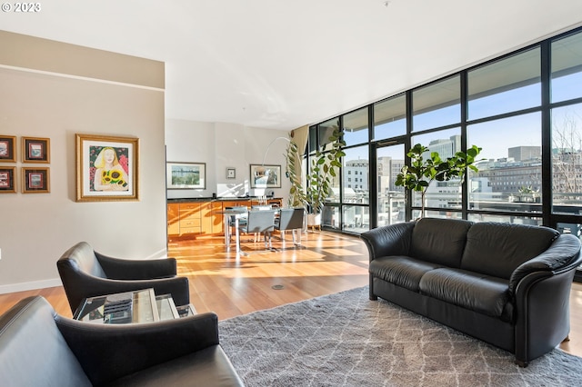 living room featuring wood-type flooring and a wall of windows