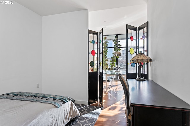 bedroom with dark wood-type flooring