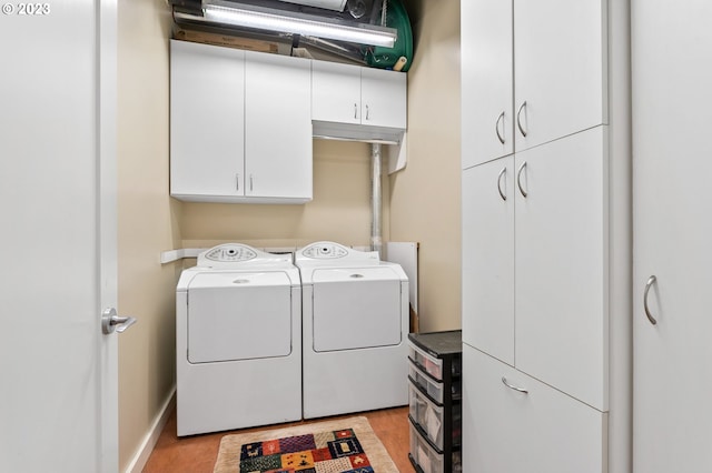 laundry area featuring cabinets and separate washer and dryer