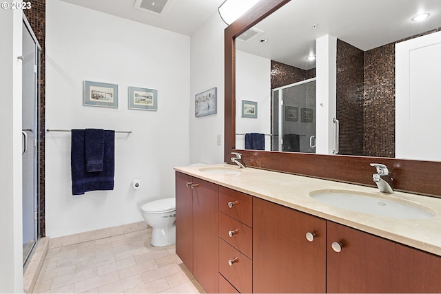 bathroom featuring vanity, a shower with shower door, tile patterned floors, and toilet