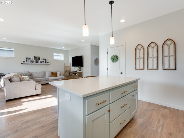 kitchen with pendant lighting, light hardwood / wood-style floors, and a center island