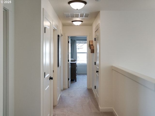 hallway featuring light carpet