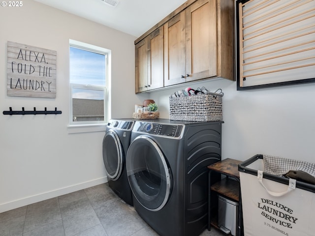 washroom with cabinets, separate washer and dryer, and light tile patterned floors