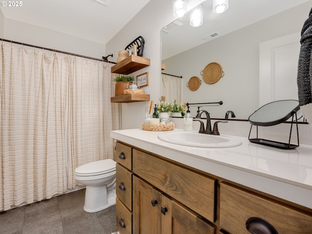 bathroom with tile patterned flooring, vanity, and toilet