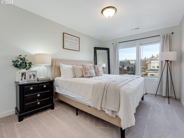 bedroom featuring light carpet