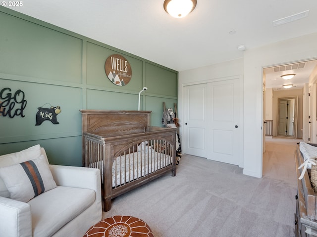 bedroom with light carpet and a closet