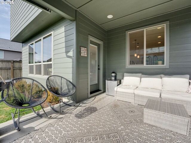 view of exterior entry with an outdoor hangout area and a patio