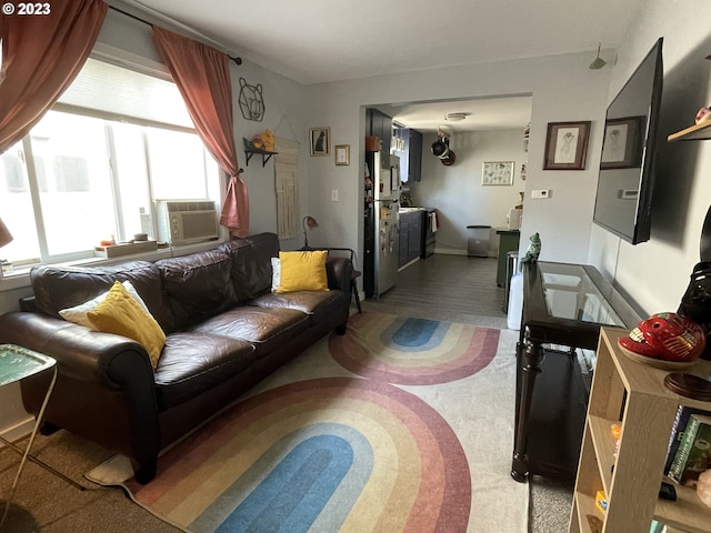 living room with cooling unit, carpet, and a healthy amount of sunlight