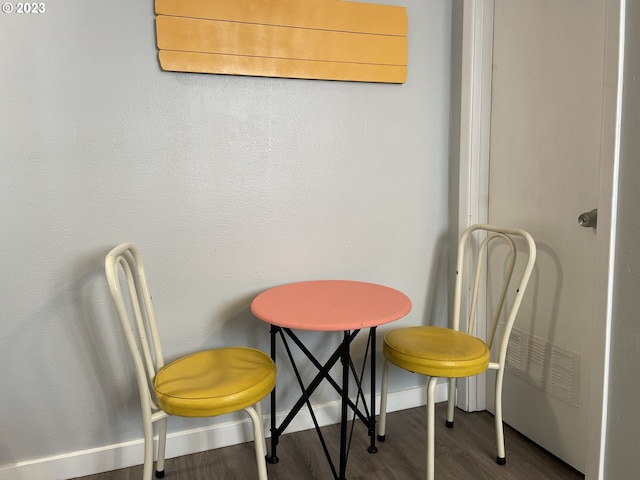 dining area featuring dark wood-type flooring