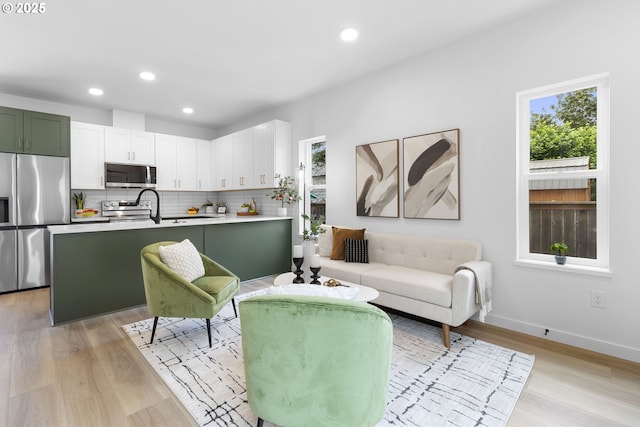 913 NE Sumner St, Portland, OR 97211 - living room featuring light wood-type flooring and recessed lighting