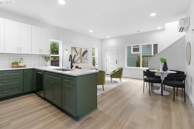 913 NE Sumner St, Portland, OR 97211 - kitchen with green cabinetry, white cabinets, a peninsula, dishwashing machine, and light countertops