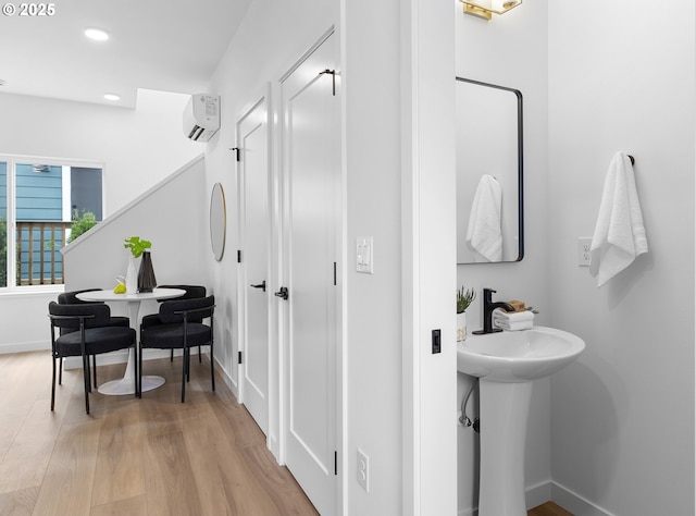 913 NE Sumner St, Portland, OR 97211 - bathroom featuring wood finished floors, recessed lighting, and a wall mounted air conditioner