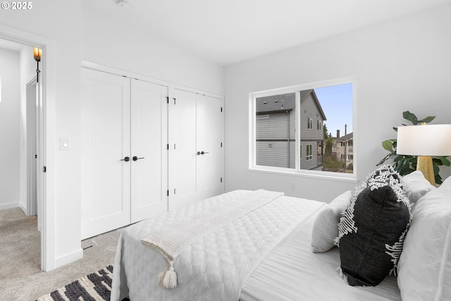 913 NE Sumner St, Portland, OR 97211 - carpeted bedroom featuring two closets and baseboards