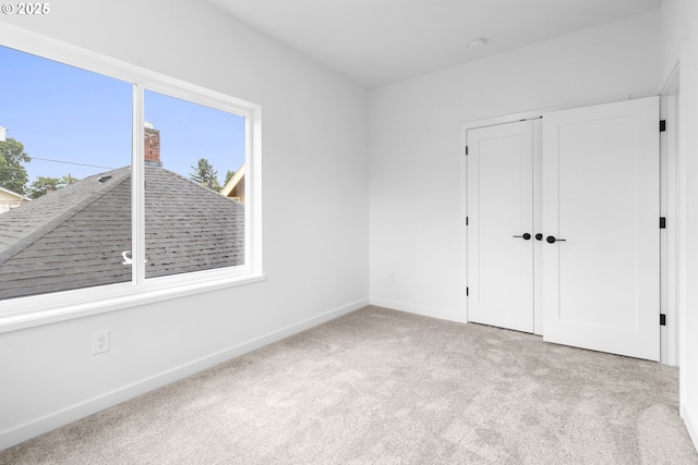 913 NE Sumner St, Portland, OR 97211 - unfurnished bedroom with multiple windows, carpet floors, and a closet