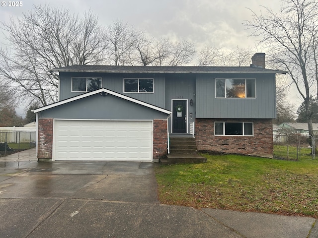 bi-level home with a garage and a front yard