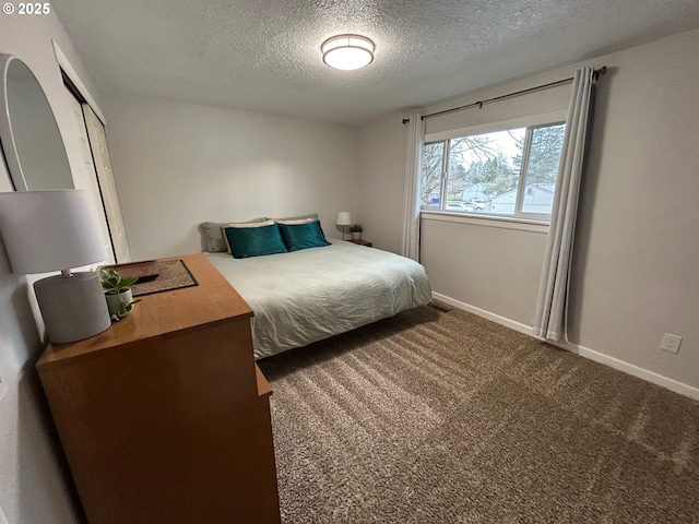 carpeted bedroom with a textured ceiling