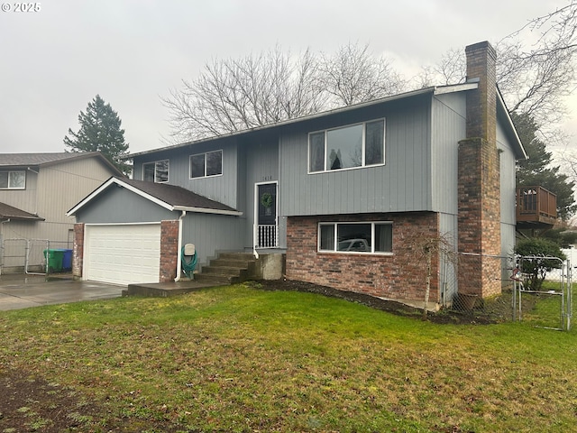 split foyer home featuring a garage and a front yard