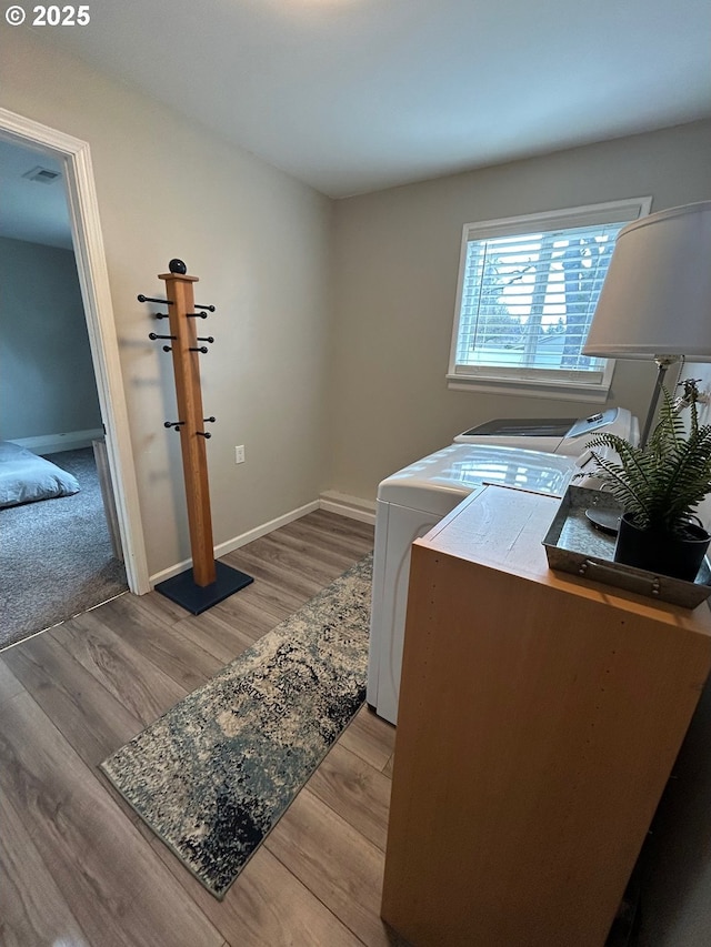 washroom featuring washer and dryer and light hardwood / wood-style flooring