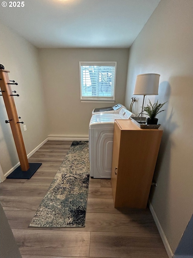 washroom featuring washing machine and dryer and hardwood / wood-style floors