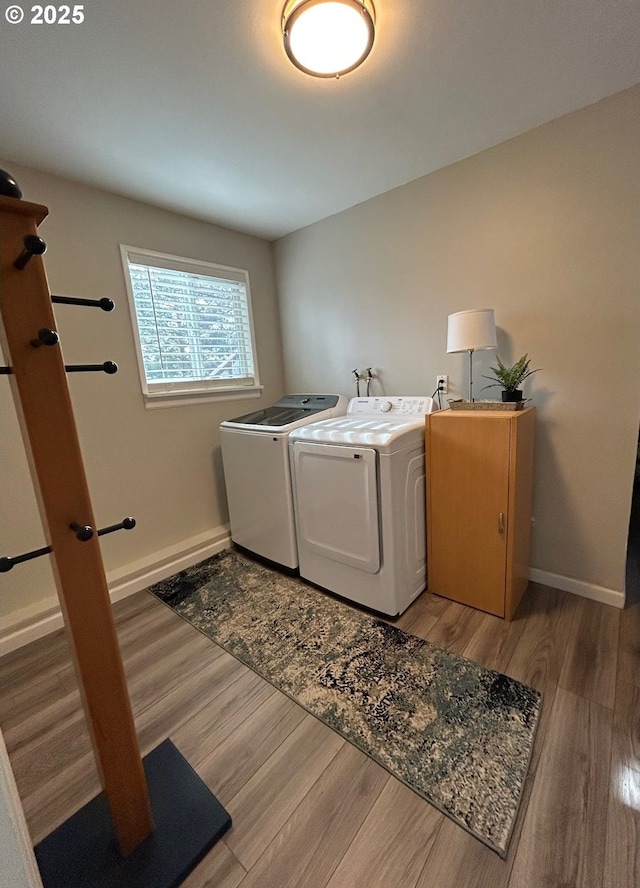 laundry room featuring hardwood / wood-style flooring and washer and clothes dryer