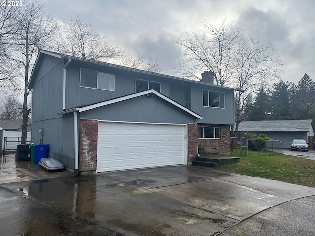 view of front of property with central AC unit and a garage