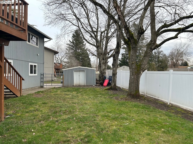 view of yard featuring a shed and a wooden deck