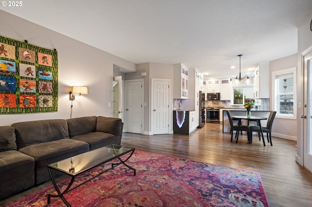28575 SW Sandalwood Dr, Wilsonville, OR 97070 - living room featuring dark wood finished floors and baseboards