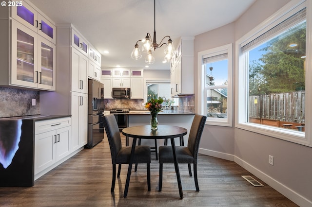 dining room featuring visible vents, baseboards, dark wood finished floors, recessed lighting, and an inviting chandelier