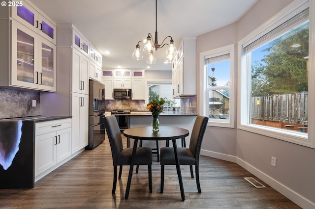 28575 SW Sandalwood Dr, Wilsonville, OR 97070 - dining area featuring a chandelier, dark wood finished floors, baseboards, and recessed lighting