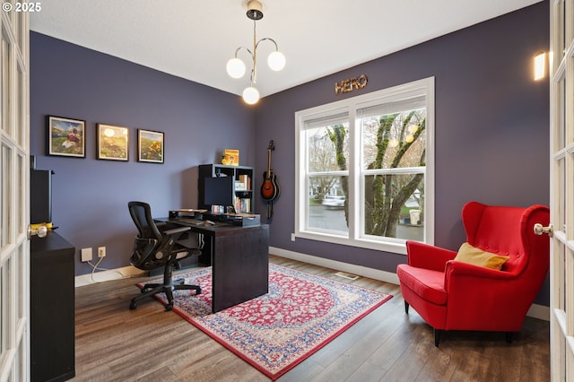 office space with visible vents, baseboards, and wood finished floors