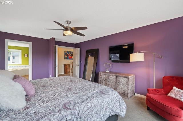 carpeted bedroom with connected bathroom, baseboards, and ceiling fan