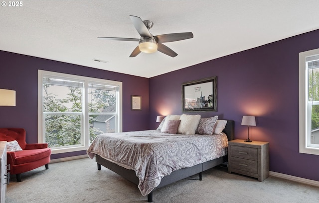 28575 SW Sandalwood Dr, Wilsonville, OR 97070 - carpeted bedroom with multiple windows, a ceiling fan, and baseboards