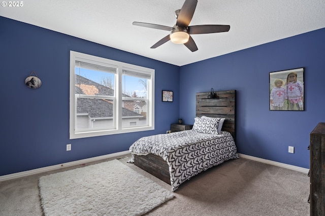 bedroom with carpet, baseboards, and a textured ceiling