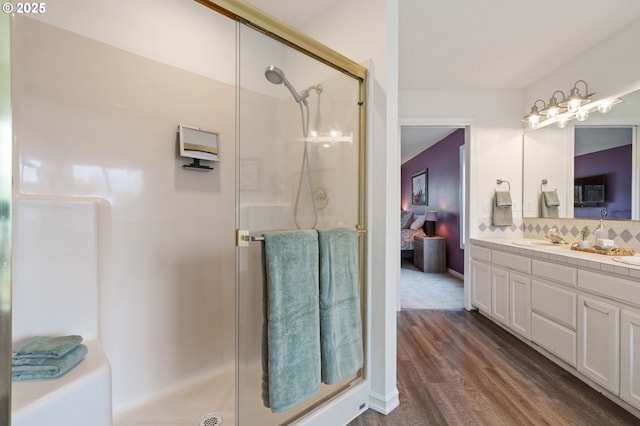28575 SW Sandalwood Dr, Wilsonville, OR 97070 - full bathroom with a shower stall, wood finished floors, vanity, and connected bathroom