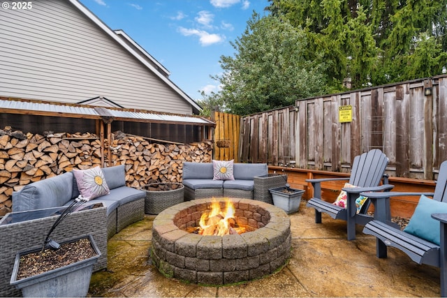 view of patio / terrace with an outdoor living space with a fire pit and fence