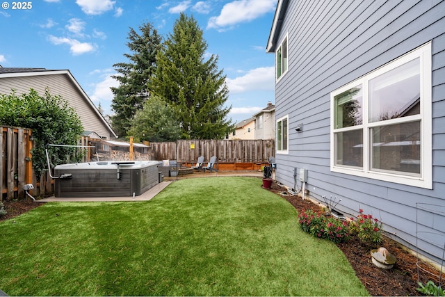 view of yard featuring a patio area, a hot tub, and a fenced backyard