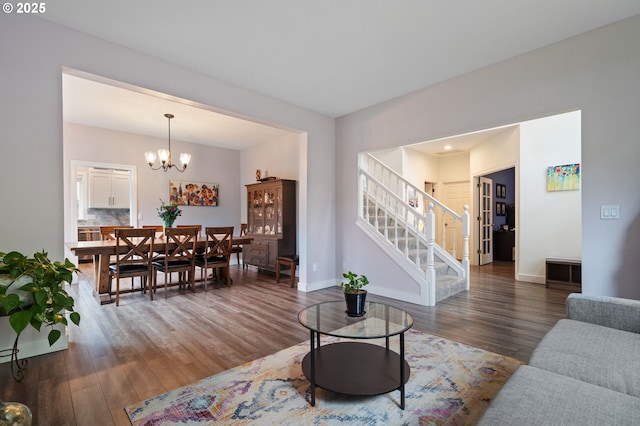 28575 SW Sandalwood Dr, Wilsonville, OR 97070 - living area with wood finished floors, stairs, baseboards, and a chandelier