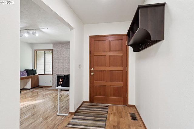 18194 Shady Hollow Way W, Linn, OR 97068 - entryway featuring light wood finished floors, a fireplace, and track lighting